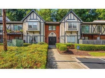 Attractive two-story home with black trimmed windows and an inviting landscaped front yard at 6851 Roswell Rd # 15, Atlanta, GA 30328