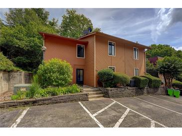 Two-story home with a brown exterior, neatly landscaped front, and convenient parking at 834 Lake Hollow Sw Blvd, Marietta, GA 30064
