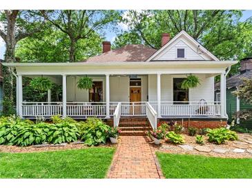 Charming home with a brick pathway, lush landscaping, and a welcoming front porch at 261 Ormond Se St, Atlanta, GA 30315