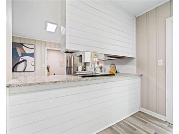 Charming kitchen featuring white cabinets, modern countertops, and stainless steel appliances at 190 Judy Sw Ln, Atlanta, GA 30315