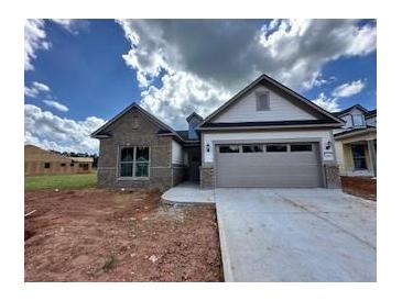 Beautiful new construction home featuring a two-car garage and modern architectural details at 5444 Miravista Way, Hoschton, GA 30548