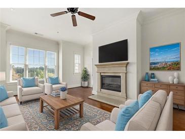 Bright living room with a fireplace, large windows, and comfortable seating arrangement at 3635 E Paces Ne Cir # 1405, Atlanta, GA 30326