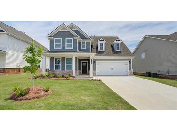 Charming two-story home featuring a well-manicured lawn and inviting front porch at 612 Gratton Ln, Mcdonough, GA 30253
