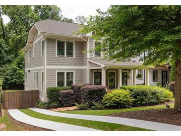 Charming home with inviting front porch, manicured landscaping, and a driveway with a green grass strip at 127 Oak Ln, Decatur, GA 30030