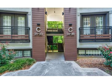 Two-story apartment building featuring wood trim and balconies with iron railings at 1445 Monroe Ne Dr # C32, Atlanta, GA 30324