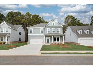 Charming two-story home with a well-manicured lawn and inviting front porch at 616 Gratton Ln, Mcdonough, GA 30253