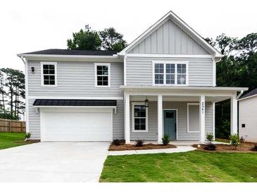Charming two-story home with gray siding, manicured lawn, and attached two-car garage at 2561 Adair Ridge Ct, Decatur, GA 30034