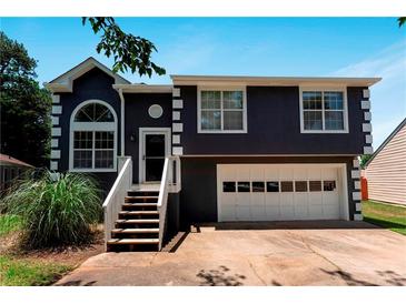 Charming two-story home featuring a front-facing garage and a welcoming entrance with a stairway and porch at 3620 Darwin Pl, Duluth, GA 30096