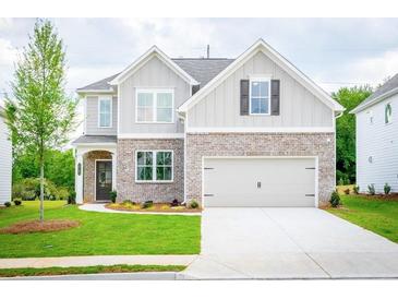 Charming two-story home with brick accents, a two-car garage, and a well-manicured lawn at 1731 Fulmont Cir, Mableton, GA 30126