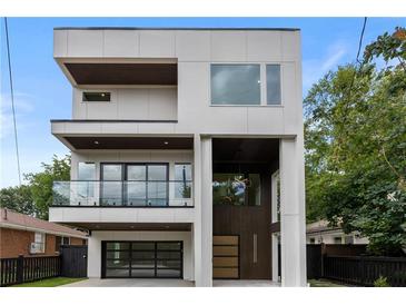 Striking modern home featuring clean lines, multiple balconies, and a sleek design with a glass garage door at 1102 Sanders Se Ave, Atlanta, GA 30316