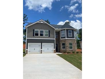 Charming two-story home featuring a two-car garage and stylish gray and brick facade at 746 Great Oak Pl, Villa Rica, GA 30180
