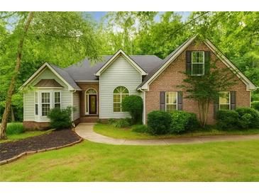 Charming home featuring a brick facade, bay window, and lush lawn at 733 Exchange Mill Pl, Dacula, GA 30019