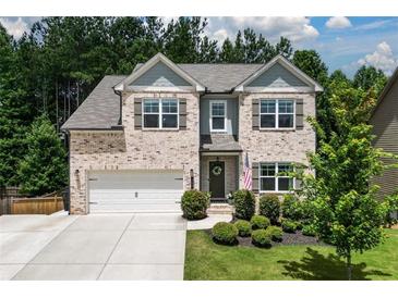 Charming two-story home with a well-manicured lawn and attached two-car garage at 302 Aspen Valley Ln, Dallas, GA 30157