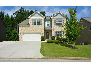 Charming two-story brick home with a well-manicured lawn and a two-car garage at 302 Aspen Valley Ln, Dallas, GA 30157