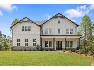 New construction two-story home with white siding, black trim, covered porch, and landscaped front yard at 4525 Aiden Way, Cumming, GA 30041