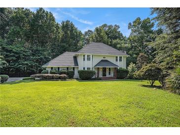 Charming two-story home with a well-manicured lawn and mature trees at 573 Hastings Way, Jonesboro, GA 30238