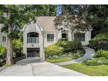 Charming painted-brick home boasts manicured landscaping, two-car garage, and a welcoming walkway at 1833 N Rock Springs Ne Rd, Atlanta, GA 30324