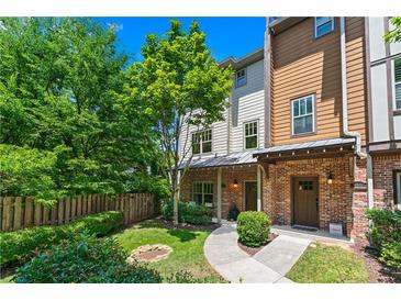 Charming townhome with brick accents, lush landscaping, and a welcoming front yard at 1325 Oakview Rd, Decatur, GA 30030