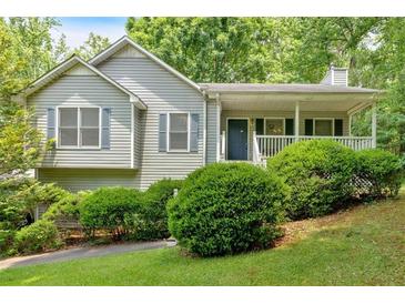 Charming single-story home with a covered front porch and well-maintained landscaping at 144 Wiley Dr, Douglasville, GA 30134