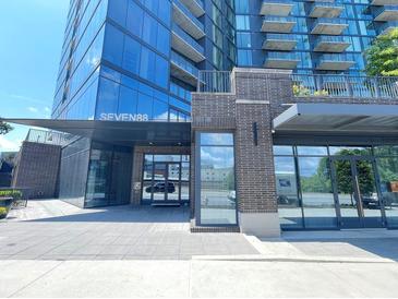Modern condominium building entrance with glass windows and brick accents at 788 W Marietta Nw St # 512, Atlanta, GA 30318