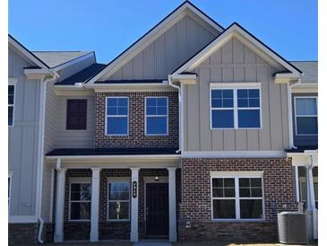 Beautiful new two-story home with brick and siding and a covered front porch at 4849 Walkers Green, Mableton, GA 30126