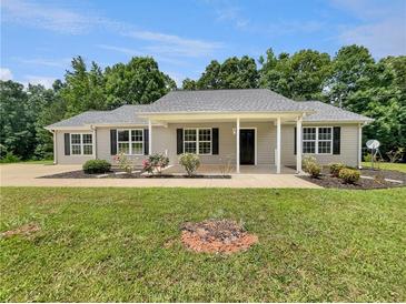 Charming ranch-style home with manicured lawn and landscaping, offering great curb appeal at 256 Prometheous Way, Rockmart, GA 30153