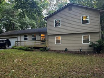 Charming two-story home featuring a combination of siding, complemented by a well-maintained lawn and natural landscaping at 3474 Leaf Land Ct, Duluth, GA 30097