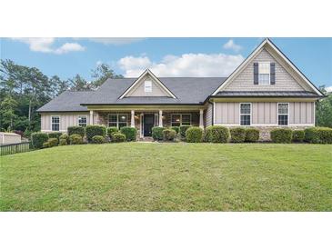 Charming home featuring beautiful stone and siding exterior with well-manicured landscaping at 2118 Braswell Ln, Loganville, GA 30052