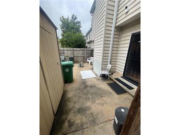 Exterior backyard view features a storage shed, concrete patio, and entrance to home at 2009 Oak Park Ln, Decatur, GA 30032