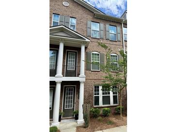 Charming brick townhouse featuring large windows and well-maintained landscaping at 531 Headwind Way, Alpharetta, GA 30005