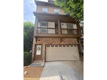 Charming two-story home with a brick facade, inviting front door, and a convenient attached garage at 3235 Chutney Ct, Avondale Estates, GA 30002