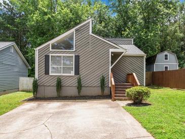 Charming home featuring a unique roofline, neutral siding, front window detail and inviting front steps at 4679 Candlewyck Way, Buford, GA 30518