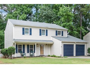 Charming two-story home featuring a well-maintained lawn, dark blue shutters and a two-car attached garage at 440 Barrington W Dr, Roswell, GA 30076