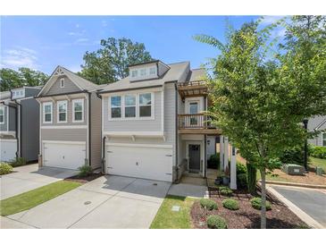Charming two-story townhome with an attached garage and a cozy second-floor balcony at 774 Belrose Dr, Smyrna, GA 30080