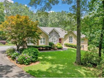 Charming single-Gathering home features a well-manicured lawn and beautiful landscaping, enhancing its curb appeal at 2140 Old Orchard Lane Ln, Canton, GA 30114
