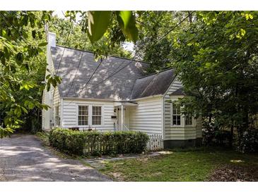 Charming cottage-style home with mature trees and a well-maintained yard provides great curb appeal at 348 7Th Ne St, Atlanta, GA 30308