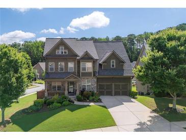 Charming two-story home with a well-manicured lawn, stone accents, and a welcoming front porch at 218 Ballymore Lane Ln, Acworth, GA 30102