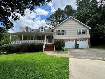 Charming home with front porch, dormer windows, attached two-car garage and well-maintained lawn at 2936 Highland Park Dr, Stone Mountain, GA 30087