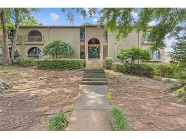 Inviting two-story condo with unique architecture, landscaping, and grand entrance staircase at 3236 Henderson Mill Rd # 1, Chamblee, GA 30341