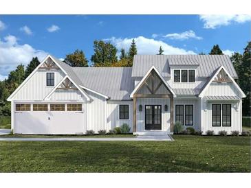 Charming white farmhouse with contrasting wood trim, a metal roof, a two-car garage and a well-manicured lawn at 571 Bearden, Douglasville, GA 30134