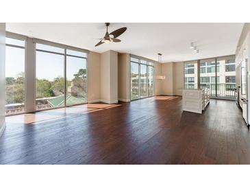 Bright, open living space with hardwood floors and floor-to-ceiling windows offering stunning views at 1820 Peachtree Nw St # 608, Atlanta, GA 30309