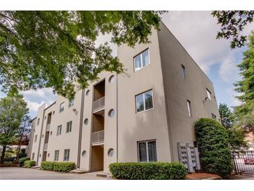Stylish building exterior featuring balconies and lush greenery at 15 Waddell Ne St # 101, Atlanta, GA 30307