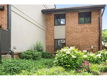A brick building has multiple windows with green foliage and plants in front of it on a sunny day at 3268 Clairmont North Ne Rd, Brookhaven, GA 30329