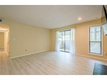 Bright living room with wood floors, sliding glass doors, and a window provide lots of natural light at 1102 Wynnes Ridge Se Cir, Marietta, GA 30067