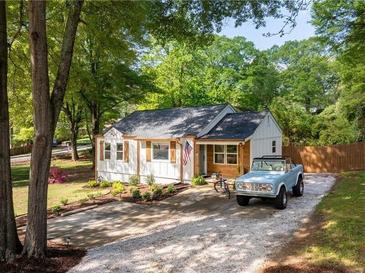 Charming single-story home with gravel driveway, landscaping, and light blue Bronco at 2086 Harold Se Ave, Smyrna, GA 30080