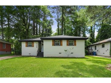 Charming single-story home featuring a freshly painted exterior and a well-manicured front yard at 3176 Pollard St, Atlanta, GA 30344