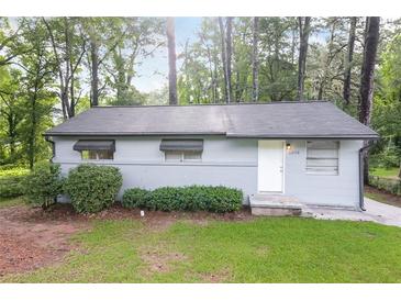 Charming single-story home with a well-maintained lawn and mature trees at 1079 Stonewall Drive Southeast, Atlanta, GA 30315