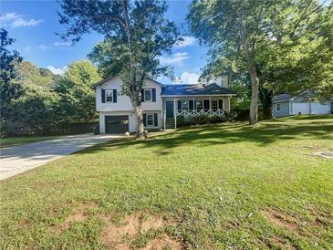 Charming two-story home featuring a well-manicured lawn, inviting front porch, and attached garage at 2955 Terry Sw Ln, Marietta, GA 30064
