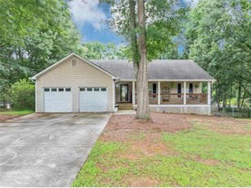 Charming single-story home featuring a covered front porch and an attached two-car garage at 250 Daileys Plantation Dr, Mcdonough, GA 30253