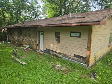 Back exterior of home needs repair and renovation to increase the appeal, along with the landscaping at 715 Plainville Sw Dr, Atlanta, GA 30331